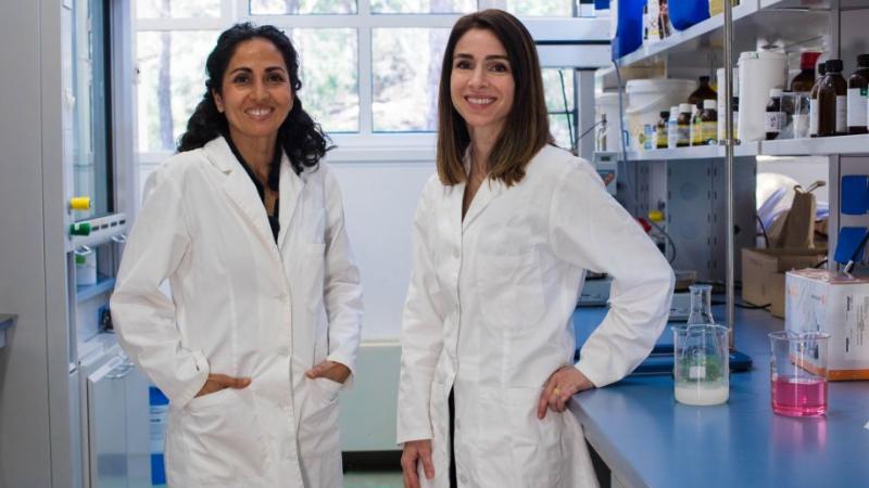 female scientists in a lab smiling